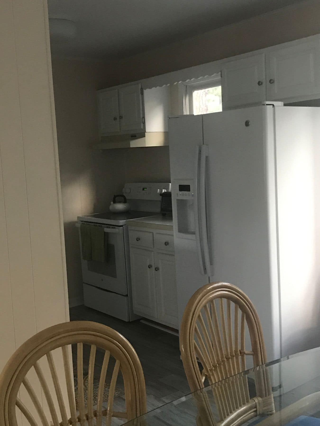 Before: a narrow galley kitchen with a white refrigerator