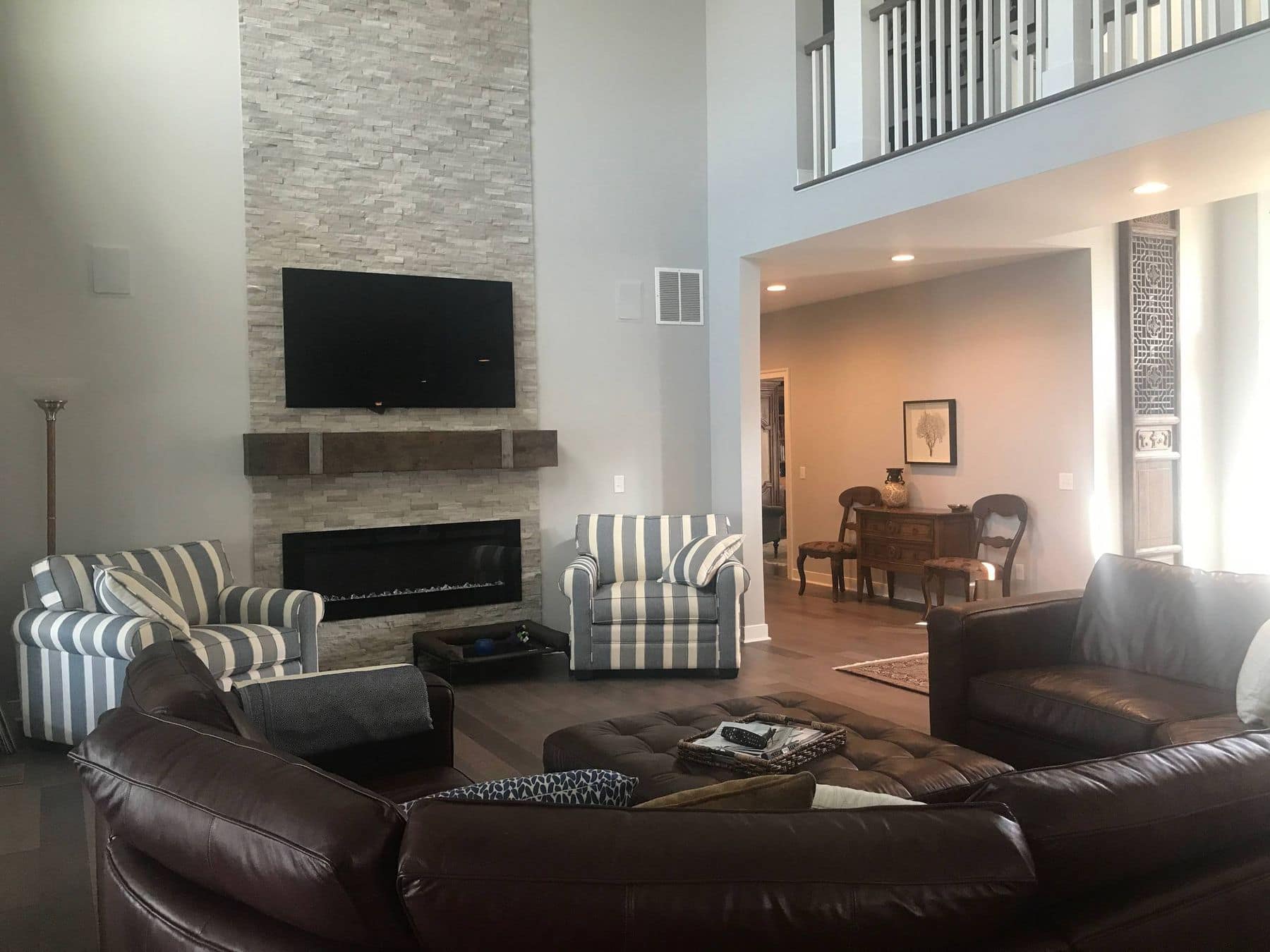 Two-story great room with a stacked-stone fireplace