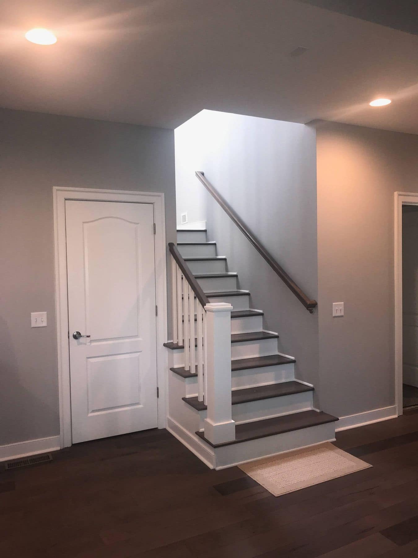 Stair with white risers and dark wood floors