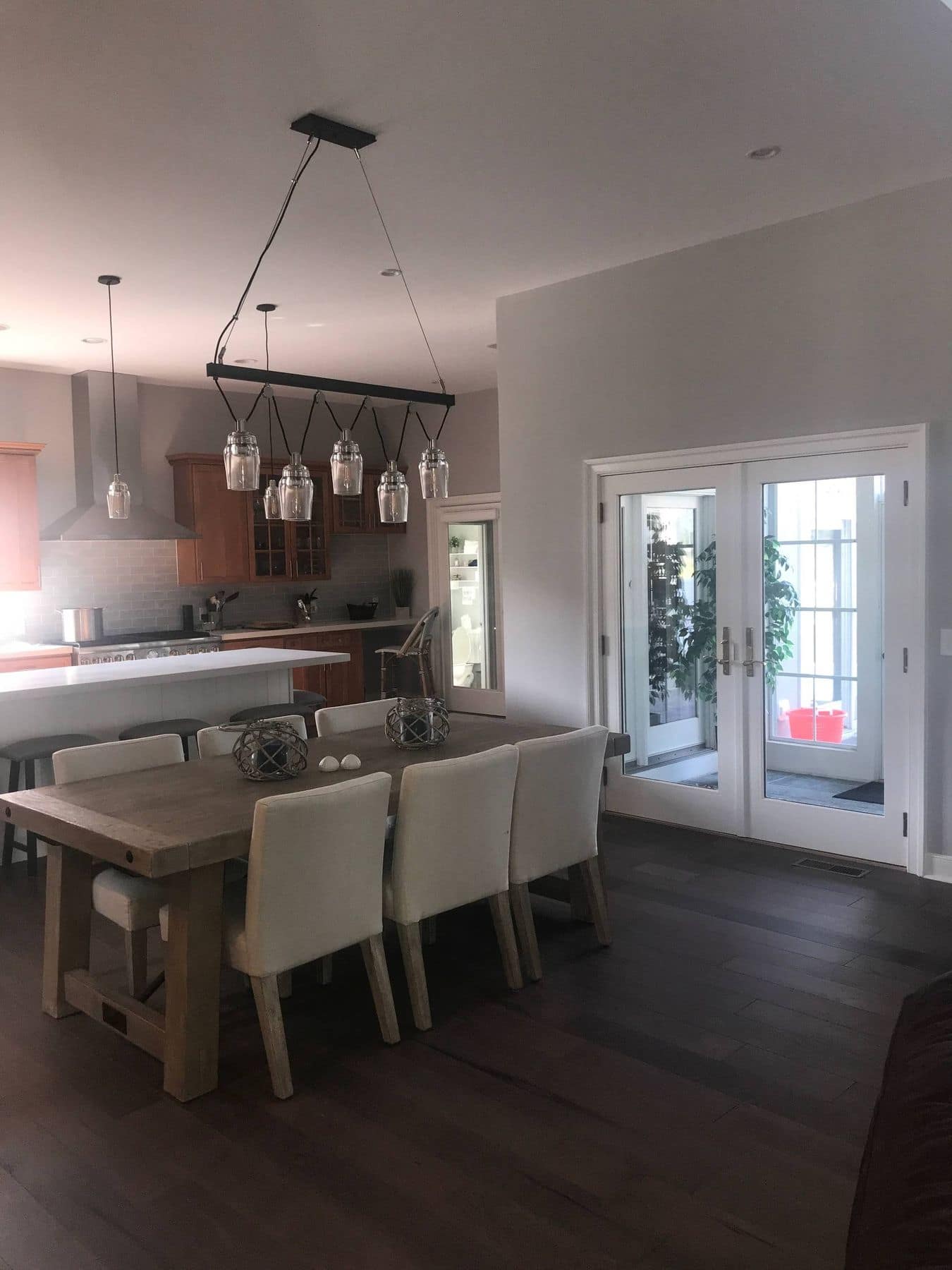 Dining area with glass pendants and French doors