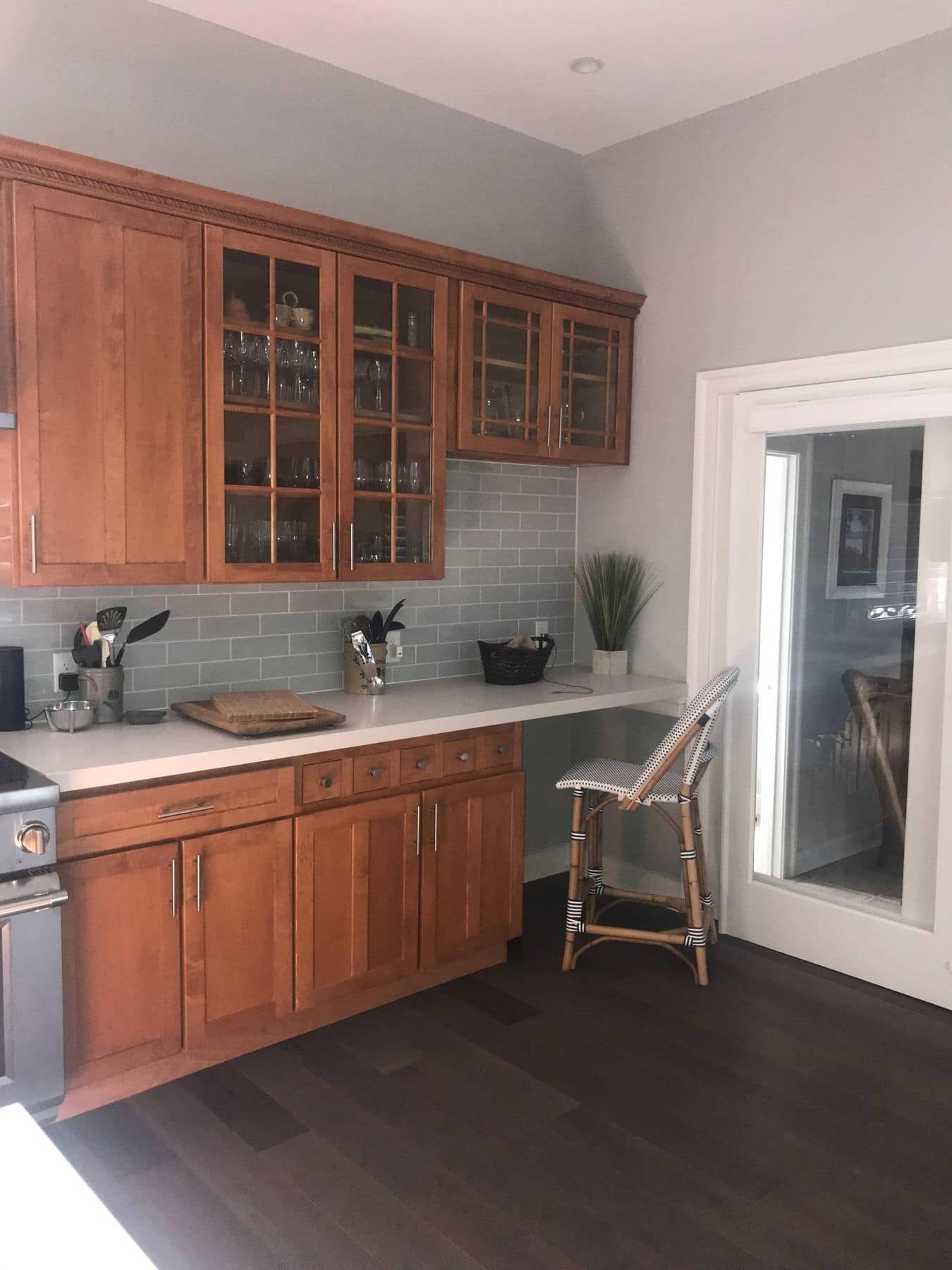 Wood cabinets and a desk beside the kitchen