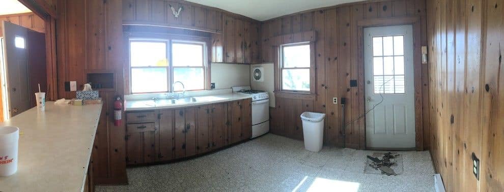 Before: a wide view of the knotty pine kitchen
