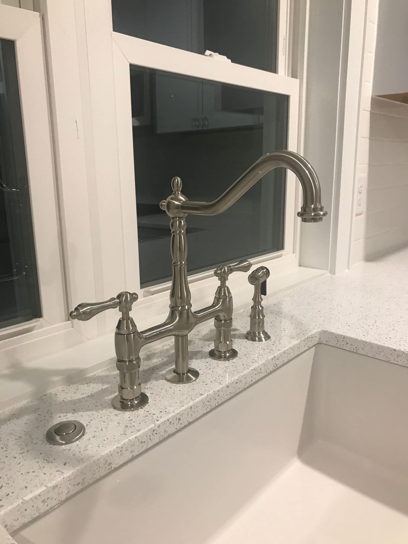 Bridge faucet over the farmhouse sink