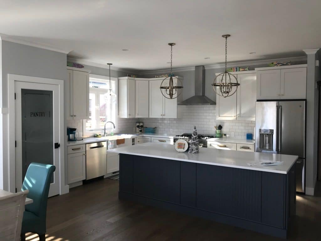 The kitchen from the pantry side, with a stainless range hood