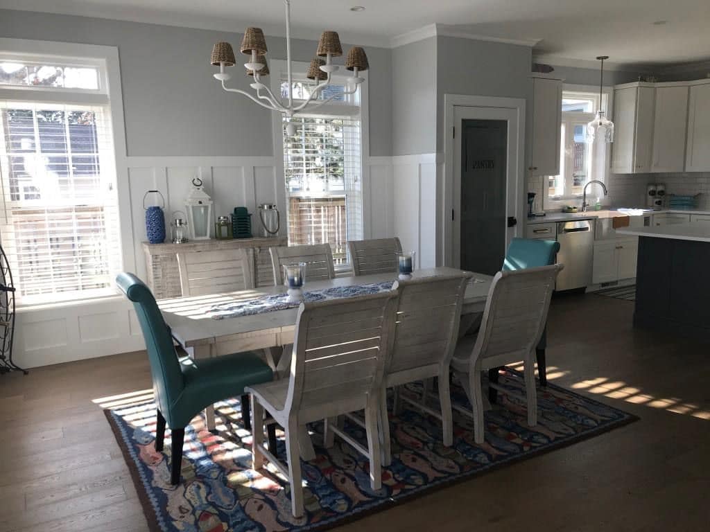 Dining room with wainscoting and tall windows