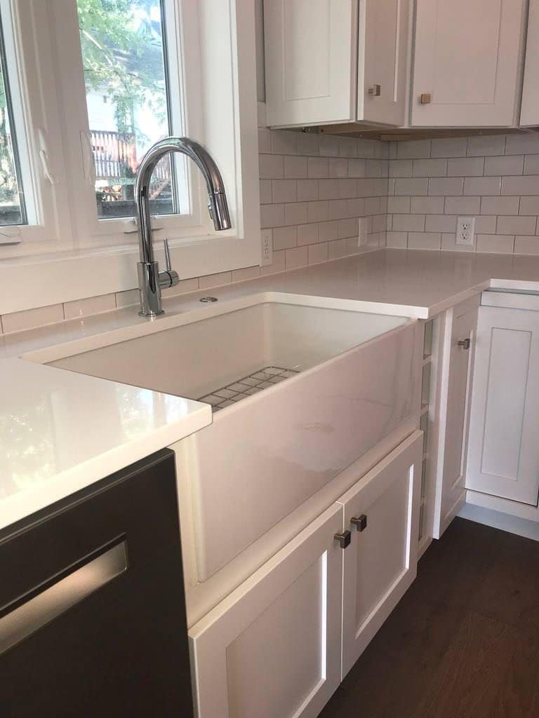 Farmhouse sink with a pull-down faucet under the window