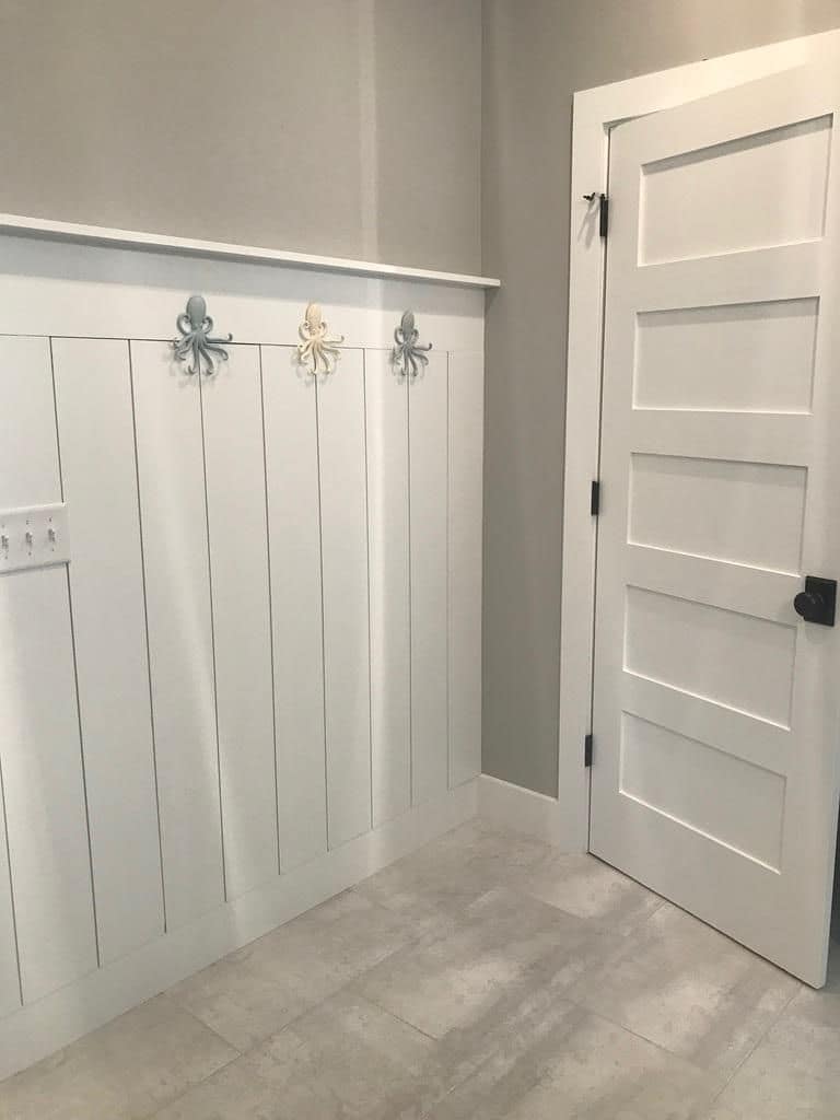 Board-and-batten mudroom wall with coat hooks
