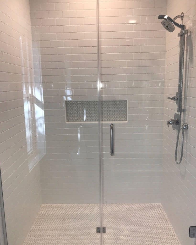 Glass shower with white subway tile