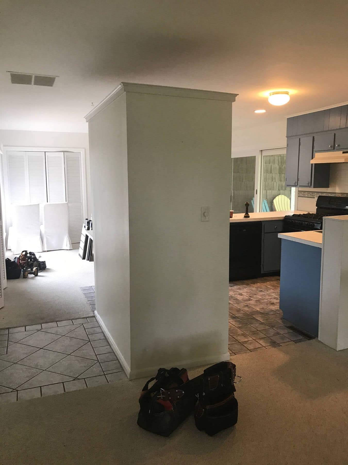Before: a wall stands between the living room and the kitchen