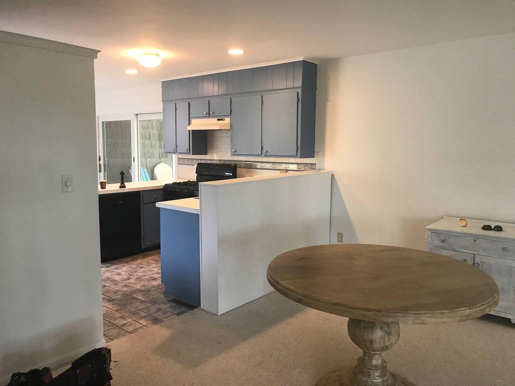 Before: blue cabinets behind a half wall
